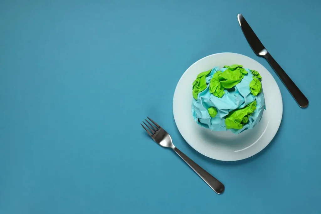 mock earth on a plate next to knife and fork