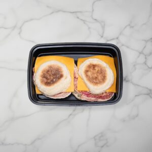 bacon egg and cheddar sandwich in tray