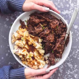 Barbacoa chuck roast served with creamy instant mashed potatoes, baby carrots, and au jus