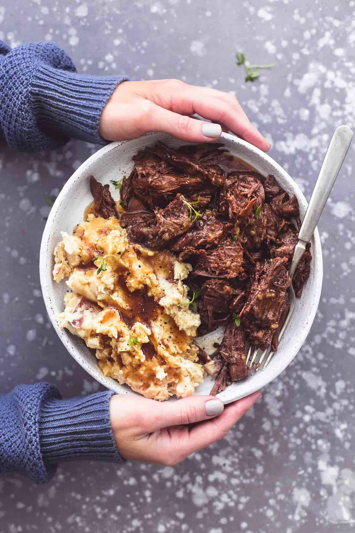 Barbacoa chuck roast served with creamy instant mashed potatoes, baby carrots, and au jus